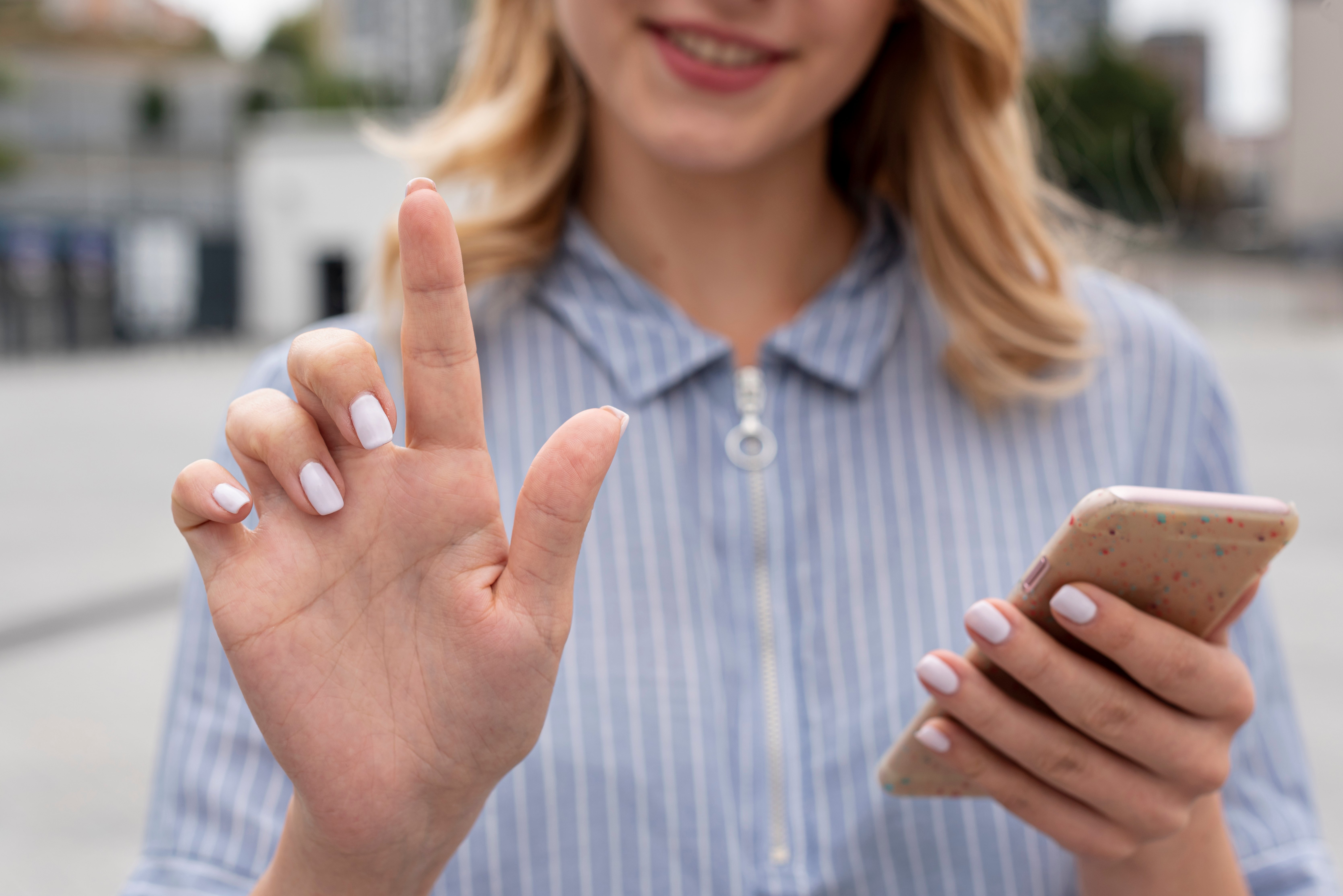 close-up-woman-holding-smartphone